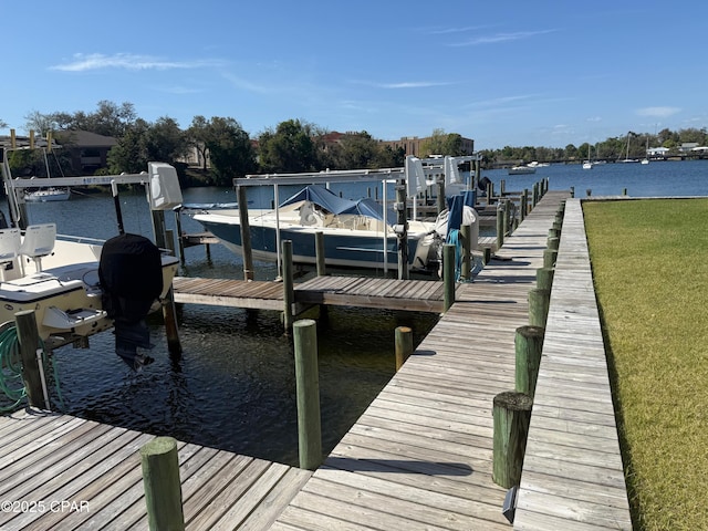 dock area featuring a yard, boat lift, and a water view
