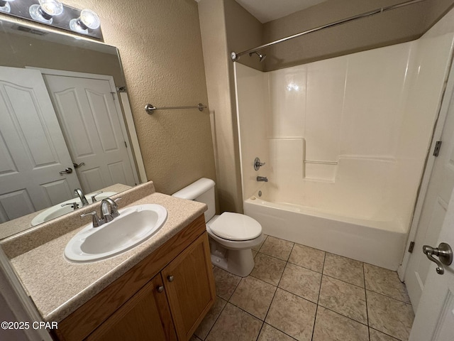 bathroom with toilet, a textured wall, vanity, and bathing tub / shower combination