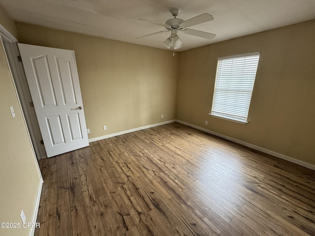 unfurnished room with baseboards, a ceiling fan, and hardwood / wood-style floors