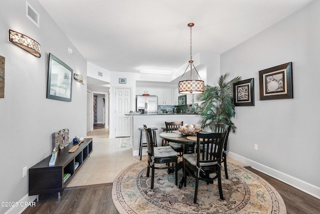 14825 Front Beach Rd Unit 2209, Panama City Beach, FL 32413 - dining room featuring baseboards and wood finished floors