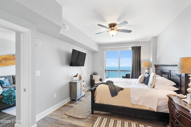 14825 Front Beach Rd Unit 2209, Panama City Beach, FL 32413 - bedroom with wood finished floors, access to outside, baseboards, ceiling fan, and a fireplace