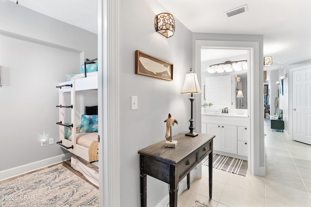14825 Front Beach Rd Unit 2209, Panama City Beach, FL 32413 - corridor with a sink, baseboards, and light tile patterned floors