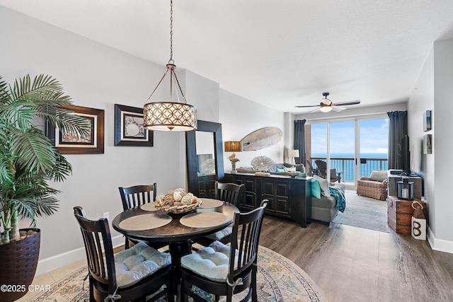 14825 Front Beach Rd Unit 2209, Panama City Beach, FL 32413 - dining area with a ceiling fan, baseboards, and light wood-type flooring