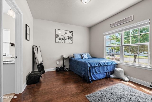 bedroom featuring baseboards and wood finished floors