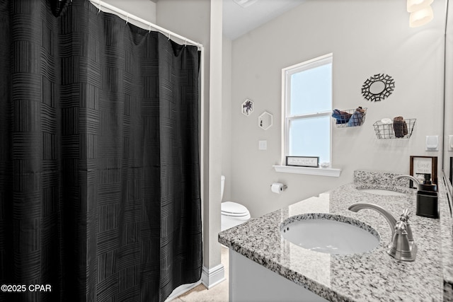 bathroom with a sink, toilet, double vanity, and a shower with shower curtain