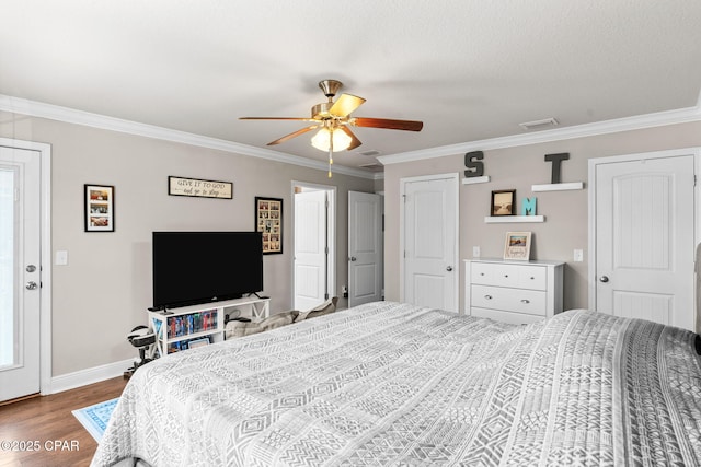 bedroom featuring visible vents, ornamental molding, baseboards, ceiling fan, and dark wood-type flooring