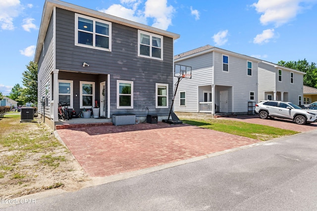 rear view of property featuring central AC