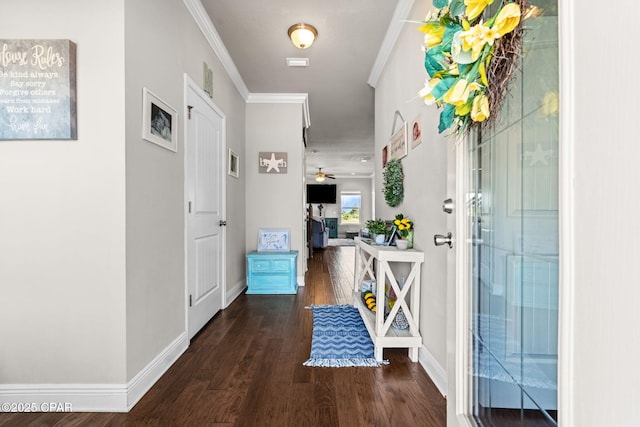 hallway featuring baseboards, ornamental molding, and wood finished floors