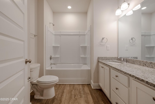 full bath with recessed lighting, vanity, bathing tub / shower combination, toilet, and wood finished floors