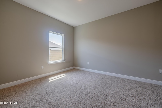 empty room with baseboards and carpet floors