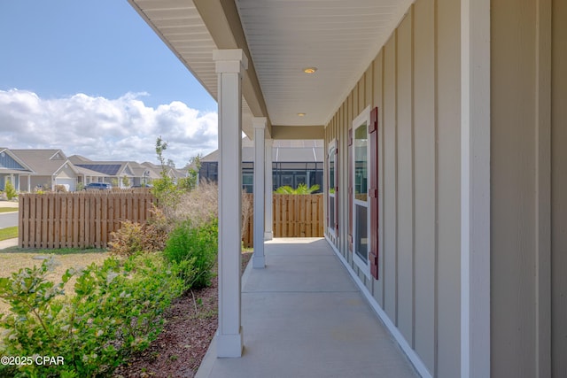 view of patio with a residential view and fence