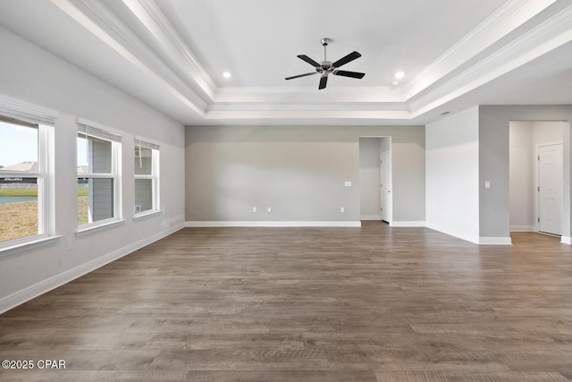 unfurnished room with crown molding, ceiling fan, baseboards, and a tray ceiling