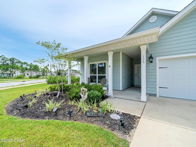 133 Stonegate Dr, Santa Rosa Beach, FL 32459 - property entrance featuring an attached garage, a lawn, and a porch