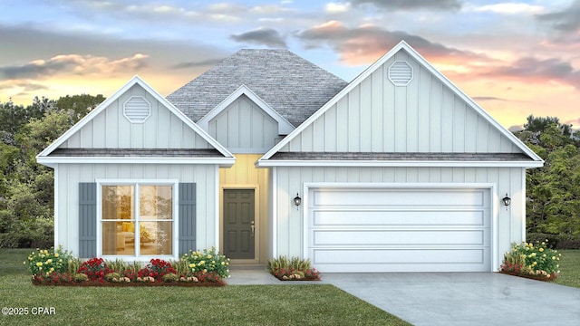 view of front of property featuring a garage, a lawn, a shingled roof, and concrete driveway