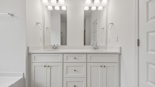 full bath featuring a sink and double vanity