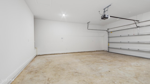 garage with a garage door opener and baseboards