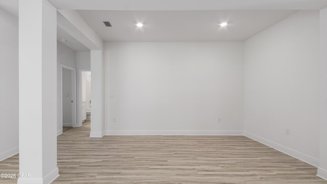 empty room featuring baseboards, recessed lighting, and light wood-style floors