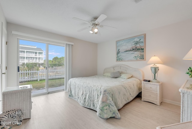 bedroom featuring light wood finished floors, baseboards, ceiling fan, and access to exterior
