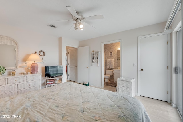 bedroom with connected bathroom, ceiling fan, visible vents, and light wood-style flooring