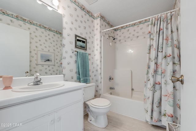 bathroom featuring wallpapered walls, shower / bathtub combination with curtain, wood finished floors, toilet, and vanity