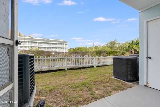 view of yard with a fenced backyard and central AC unit