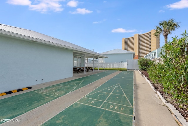 surrounding community with shuffleboard and fence