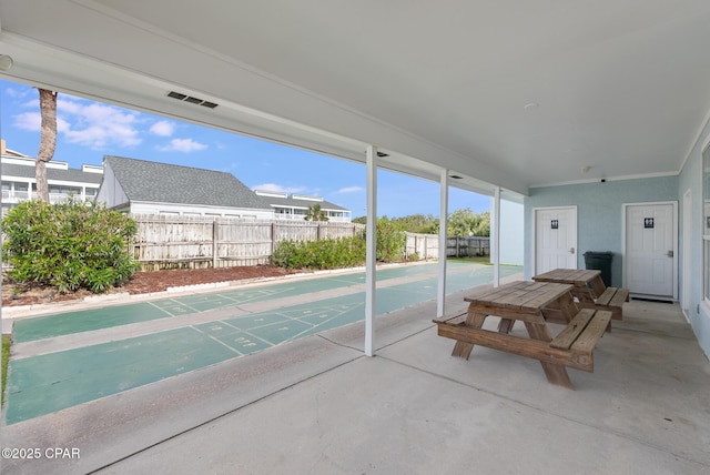 view of community featuring shuffleboard and fence