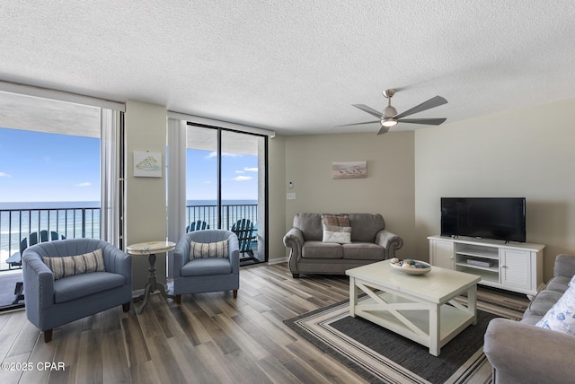 17155 Front Beach Rd Unit E602, Panama City Beach, FL 32413 - living room with wood finished floors, a ceiling fan, healthy amount of natural light, a textured ceiling, and floor to ceiling windows