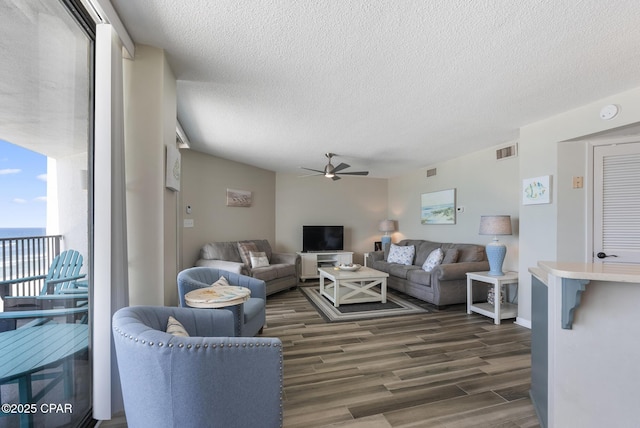 17155 Front Beach Rd Unit E602, Panama City Beach, FL 32413 - living room with ceiling fan, dark wood-type flooring, and a textured ceiling