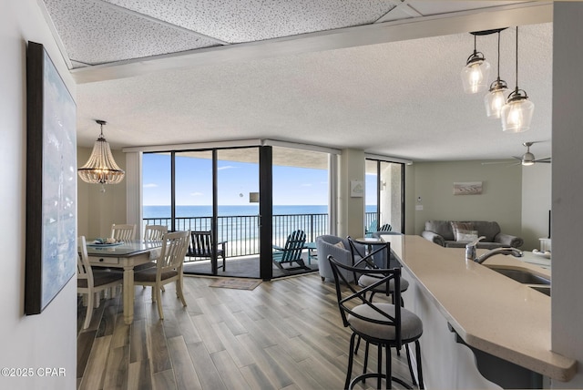 17155 Front Beach Rd Unit E602, Panama City Beach, FL 32413 - kitchen with floor to ceiling windows, a sink, a water view, wood finished floors, and open floor plan