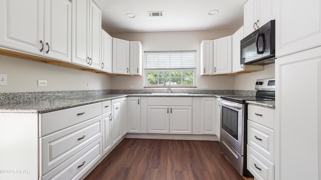 kitchen featuring a sink, black microwave, electric range, white cabinetry, and dark wood-style floors