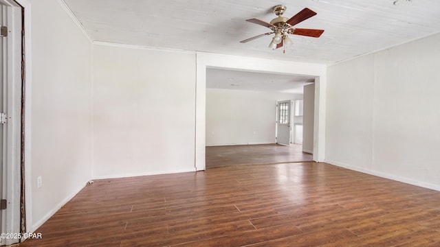 empty room with a ceiling fan, wood finished floors, and crown molding