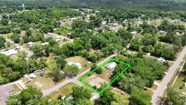 bird's eye view with a wooded view