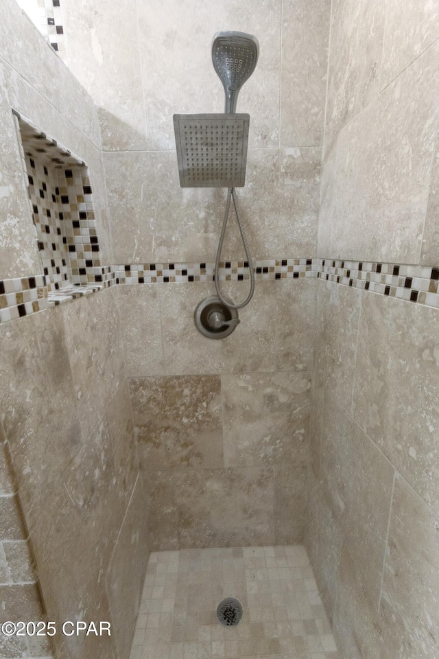 bathroom with a tile shower