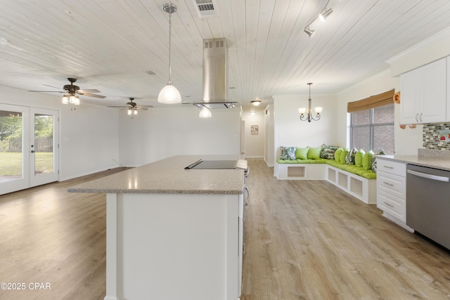 kitchen with stainless steel dishwasher, island range hood, visible vents, open floor plan, and light wood finished floors