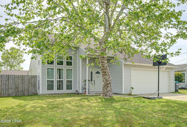 view of front of house with an attached garage, fence, driveway, and a front yard