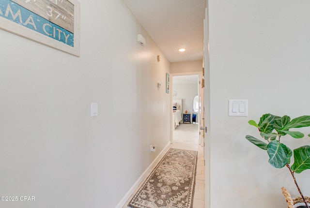hallway with recessed lighting, baseboards, and light tile patterned flooring