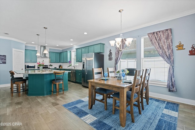 dining room with baseboards, a notable chandelier, ornamental molding, and light wood-style flooring