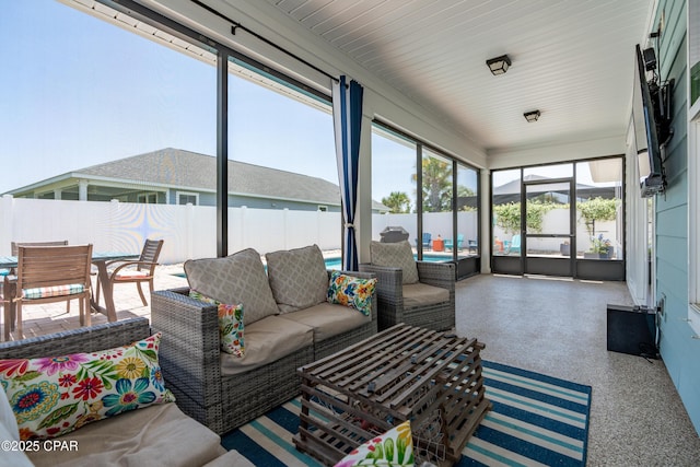 sunroom featuring outdoor dining area and outdoor lounge area