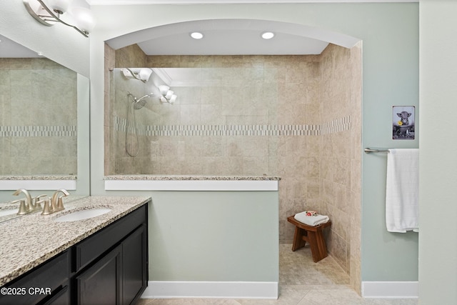bathroom with vanity, tile patterned flooring, walk in shower, and tile walls