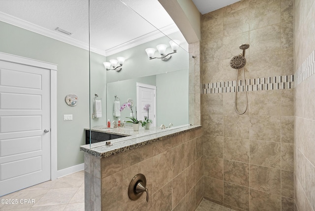 full bath with visible vents, crown molding, a sink, and walk in shower