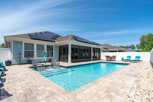 view of pool with a fenced in pool, a fenced backyard, a sunroom, and a patio area