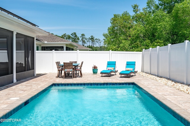 view of swimming pool featuring a patio, a fenced backyard, outdoor dining area, and a fenced in pool