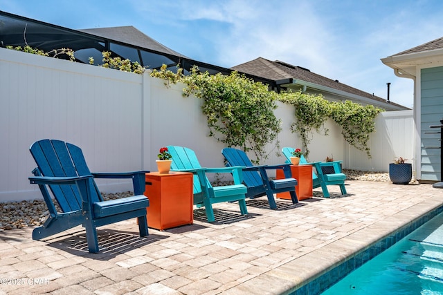 view of patio / terrace featuring fence and a pool