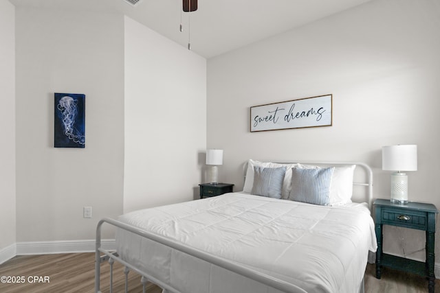 bedroom with baseboards, ceiling fan, and wood finished floors