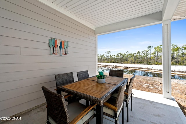 view of patio / terrace featuring outdoor dining area and a water view