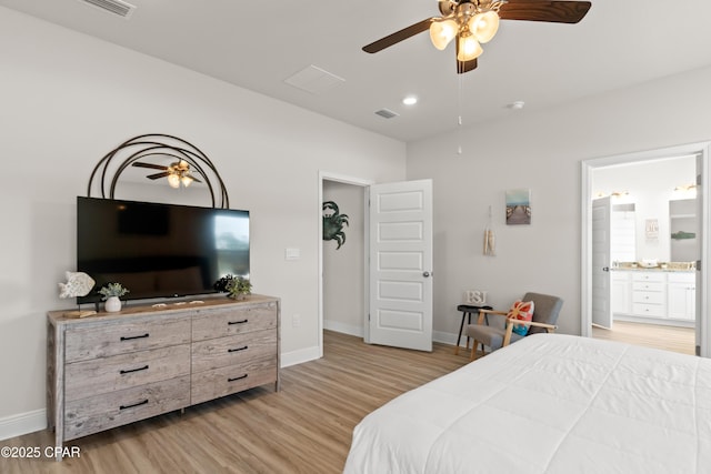 bedroom featuring baseboards, light wood-type flooring, connected bathroom, and visible vents