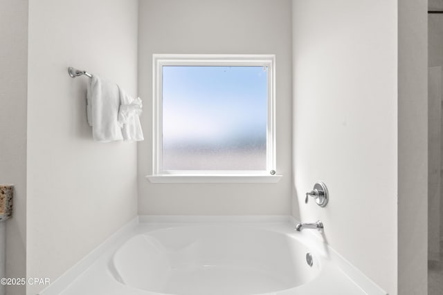 bathroom with a garden tub