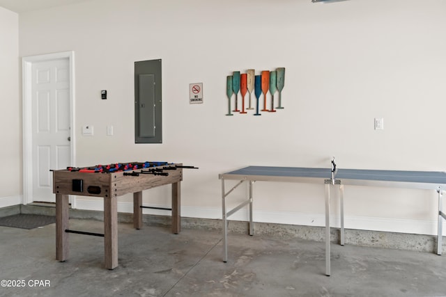 game room featuring baseboards, electric panel, and unfinished concrete floors