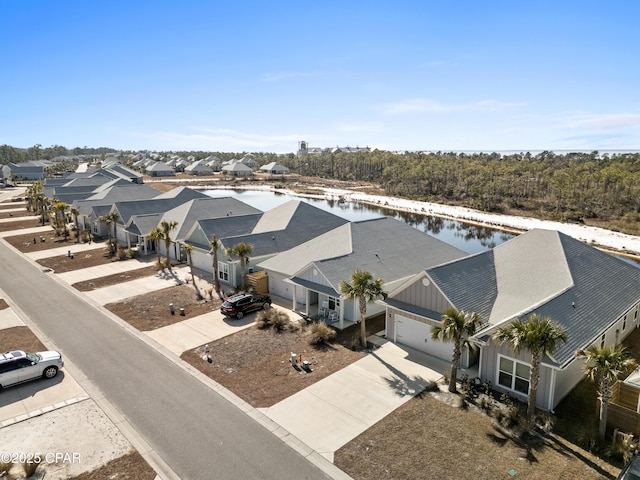 drone / aerial view with a water view and a residential view
